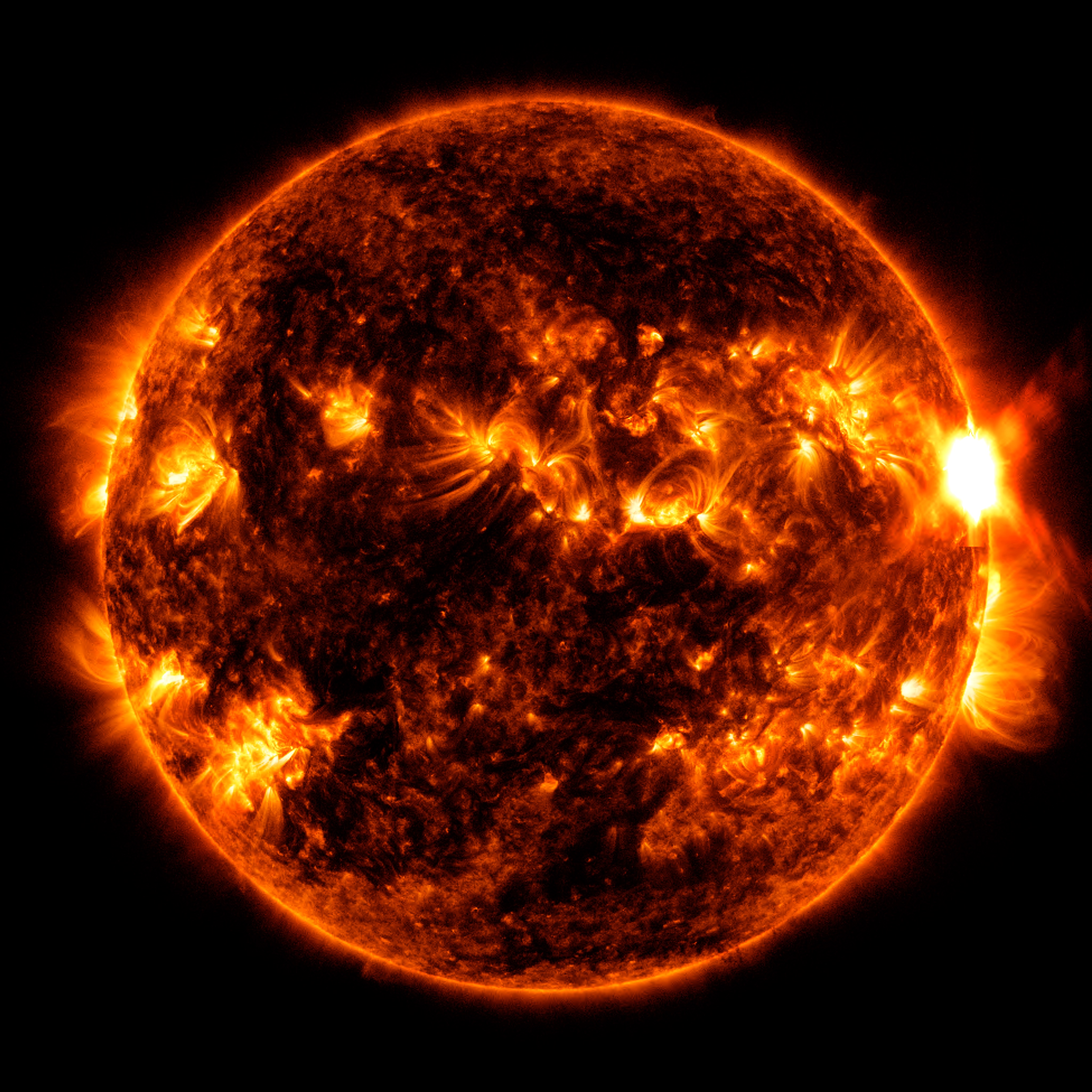 NASA’s Solar Dynamics Observatory captured this image of a solar flare – as seen in the bright flash on the right – on Aug. 5. 2023. The image shows a blend of extreme ultraviolet light that highlights the extremely hot material in flares and which is colorized in red and orange.Credit: NASA/GSFC/SDO