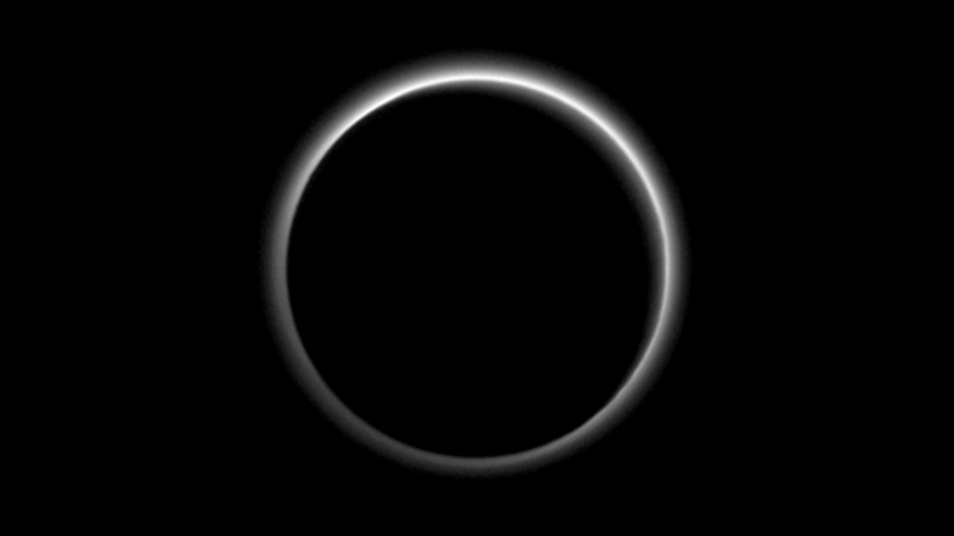  A photo of Pluto backlit by the sun reveals a layer of haze