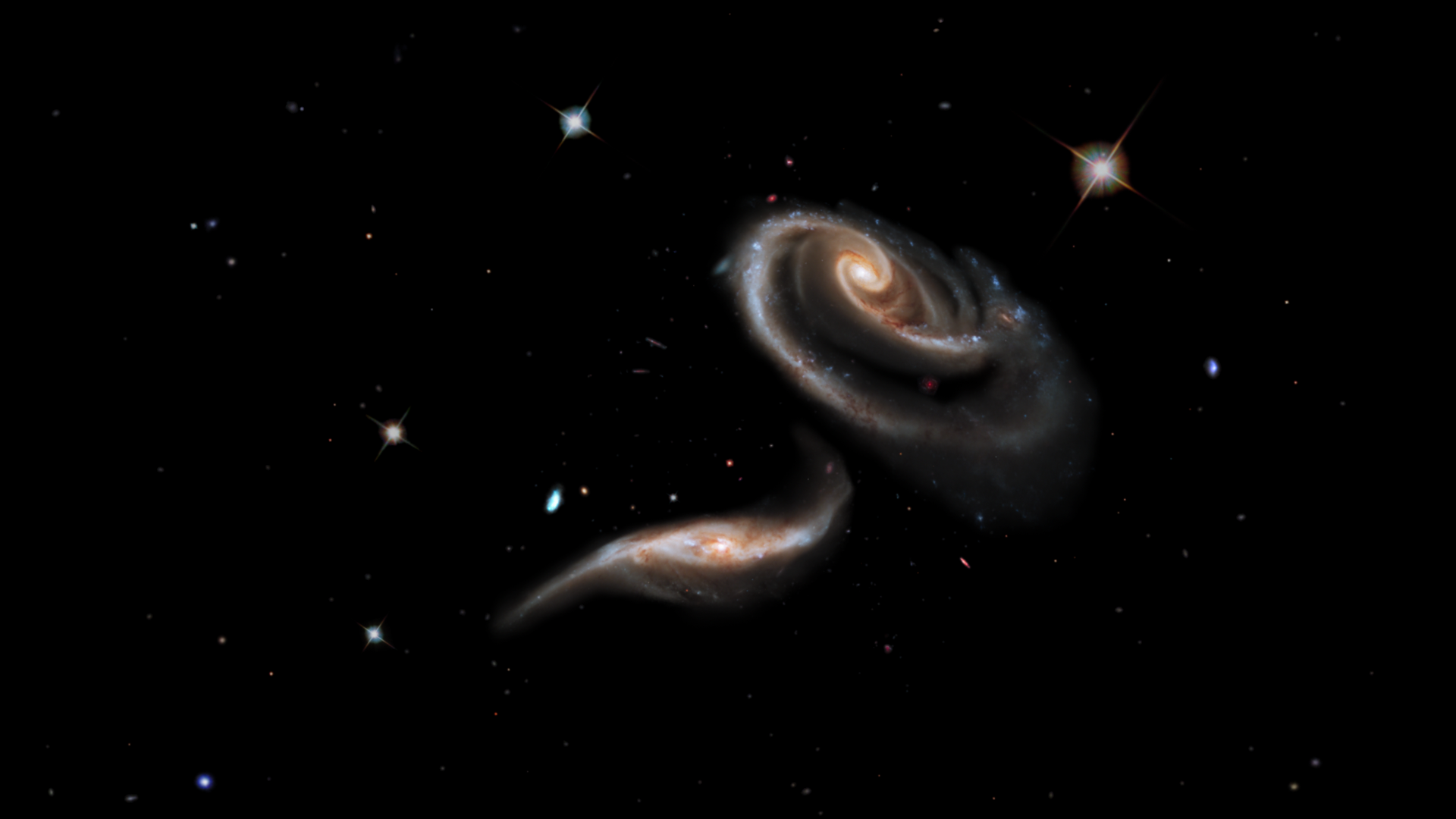 Known as Arp 273, these two galaxies have been distorted by their mutual gravitaional pull into a shape resembling a long-stemmed rose.
